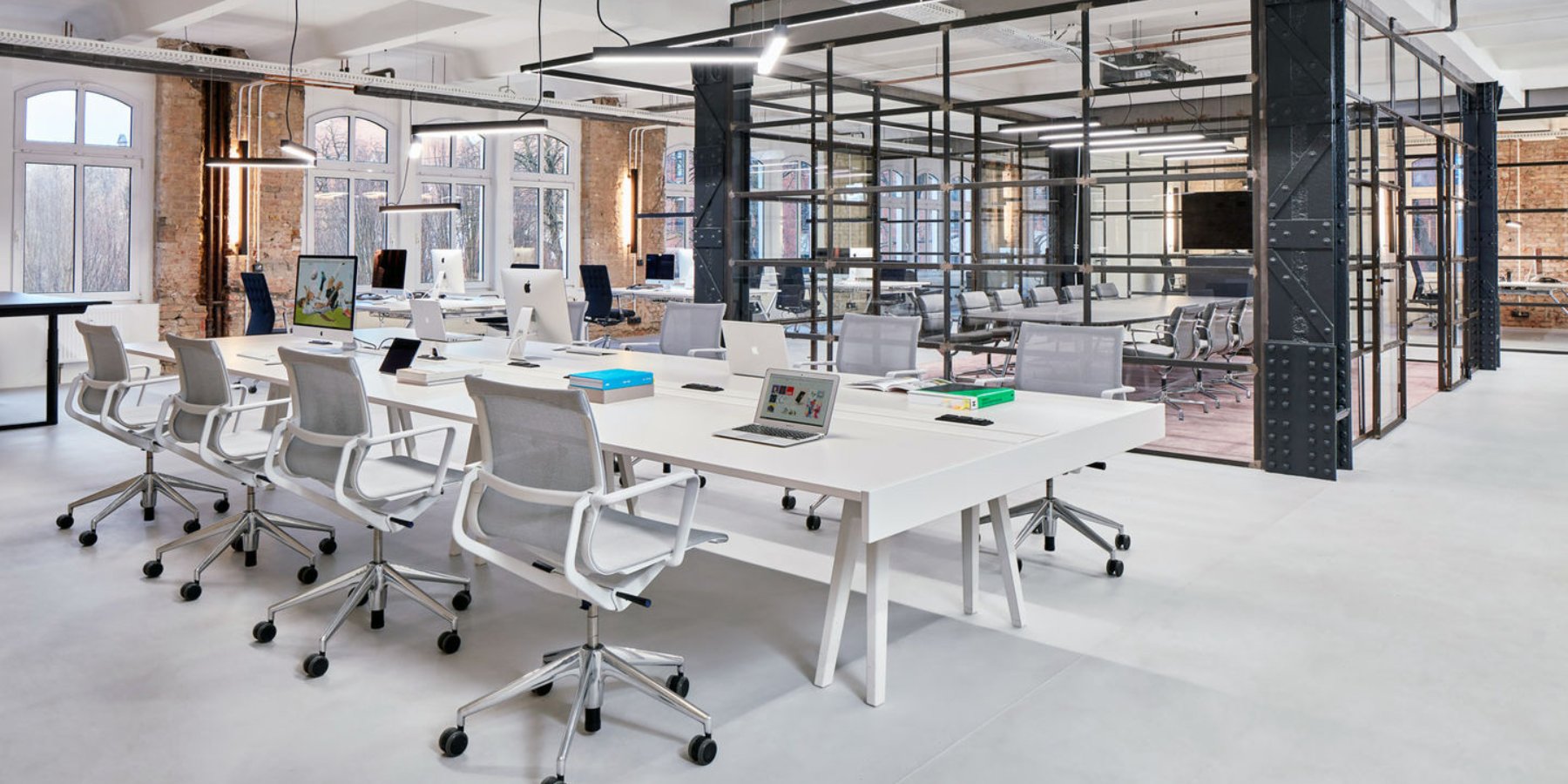 Elegant and minimalist USM office desk in a polished white finish, featuring modular design with built-in storage compartments, ideal for contemporary workspaces.